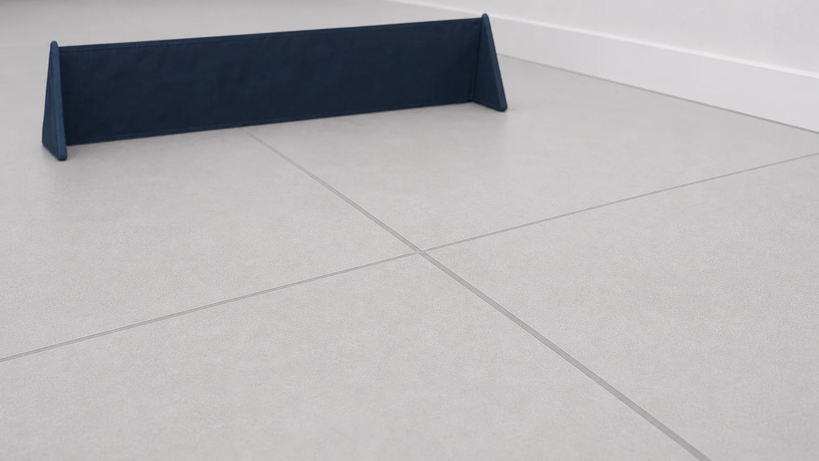 Completed grout joint appearing smooth and flush with tiles, left undisturbed to cure.