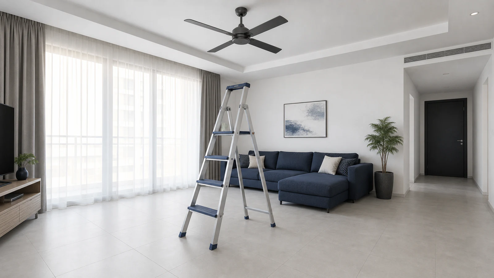 Step ladder positioned directly under a ceiling fan, feet flat on level flooring.