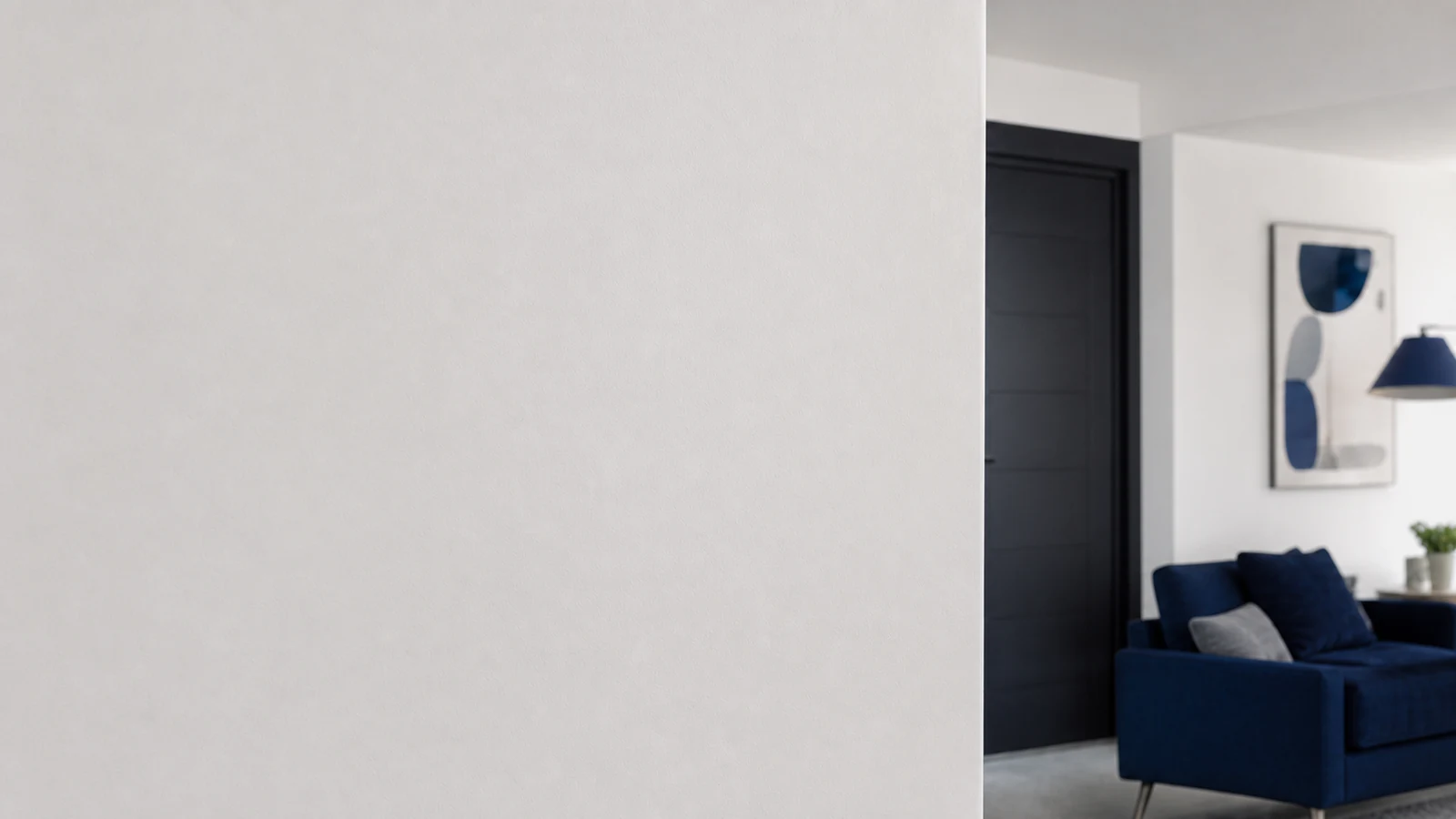 Person standing at normal room distance viewing a painted wall where a hook was removed, the wall is clean and unmarred, natural daylight from a window illuminating the surface, showing the successful result.