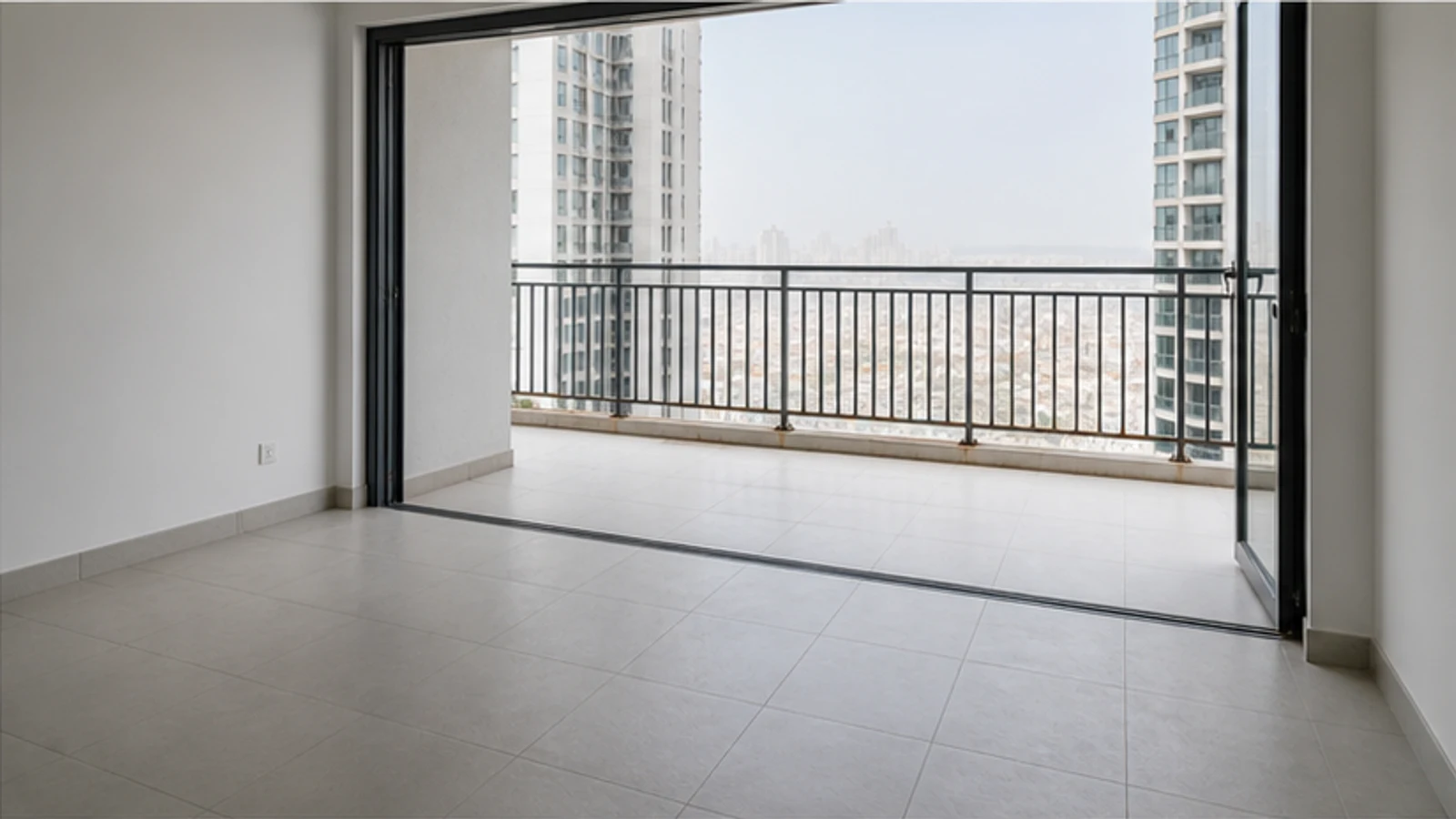 Balcony railing viewed from the apartment doorway with the area kept clear and no contact with the barrier.