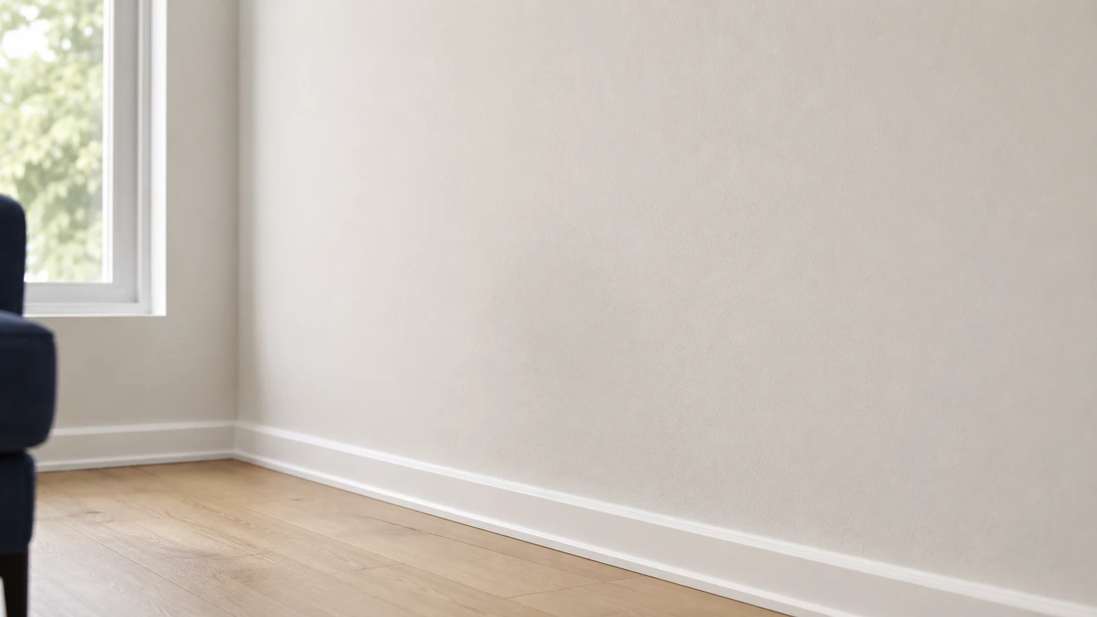 Close-up of dry wall section after cleaning, uniform paint finish with soft natural light highlighting clean surface